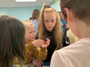 Students look at Lego pieces.