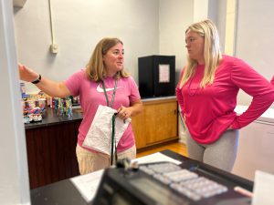 Teacher talking to student in The Armory.