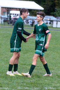 Teammate shakes Austin's hand.