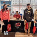 Students stand in front of SADD display.