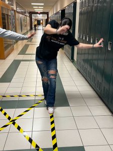 Student attempts to walk a straight line while wearing "drunk" goggles.
