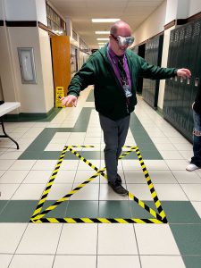 Superintendent Mark Place attempts to walk a straight line while wearing "drunk" goggles.