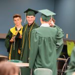 Students wearing graduation caps and gowns.