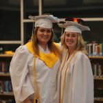 Students wearing graduation caps and gowns.