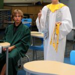 Students wearing graduation caps and gowns.