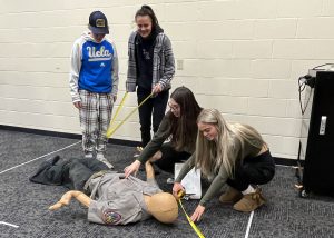 Students work with emergency dummy.