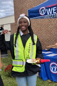 Student who is wearing a reflective security vest.