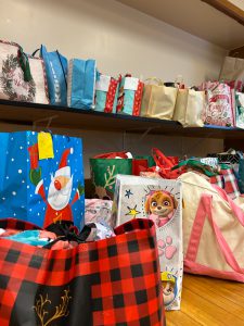 Rows of gift bags, some with Santa or cartoon characters.