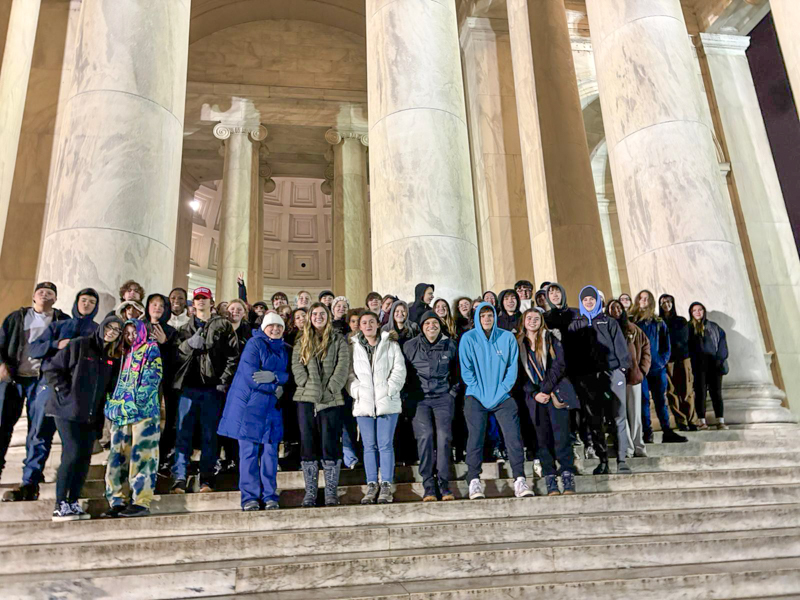 Students and teachers stand at entrance to U.S. Capitol.