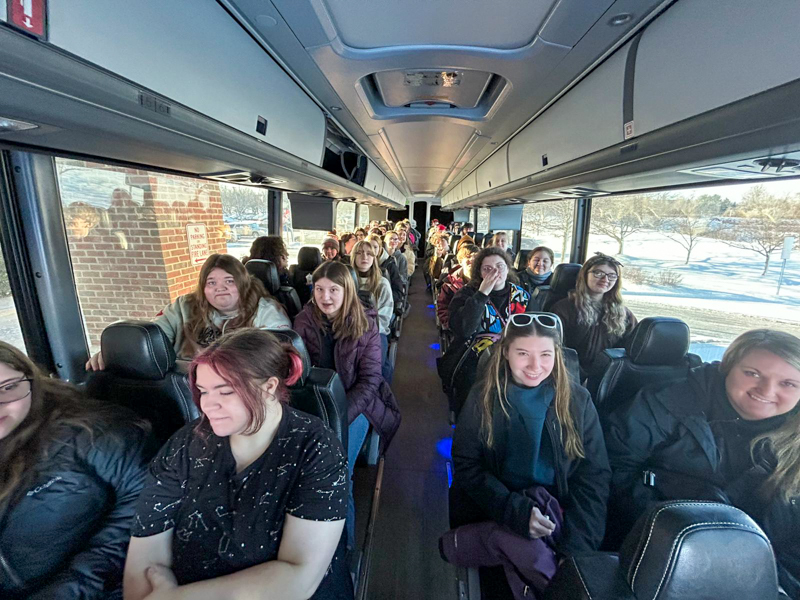 Students and teachers inside a bus.