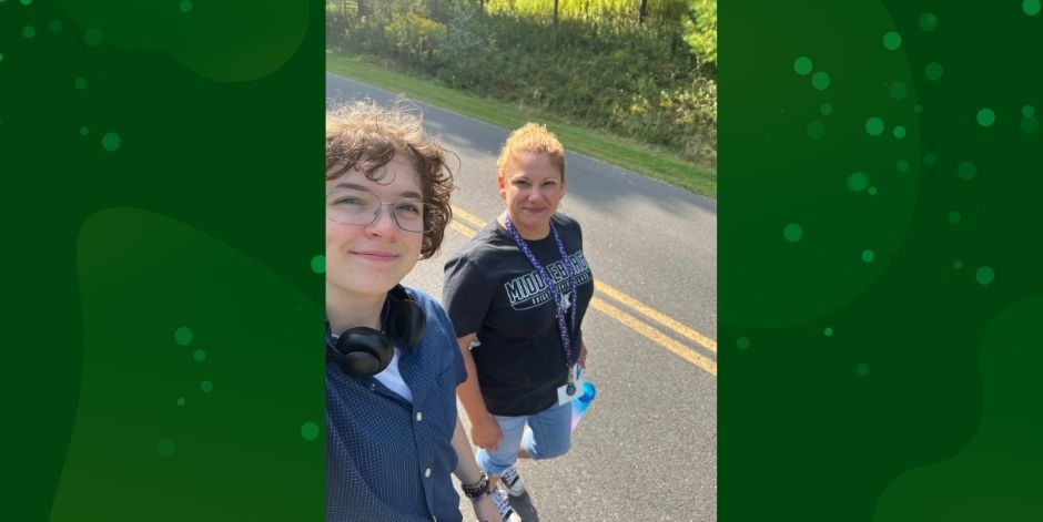 Student and teacher walk down road.